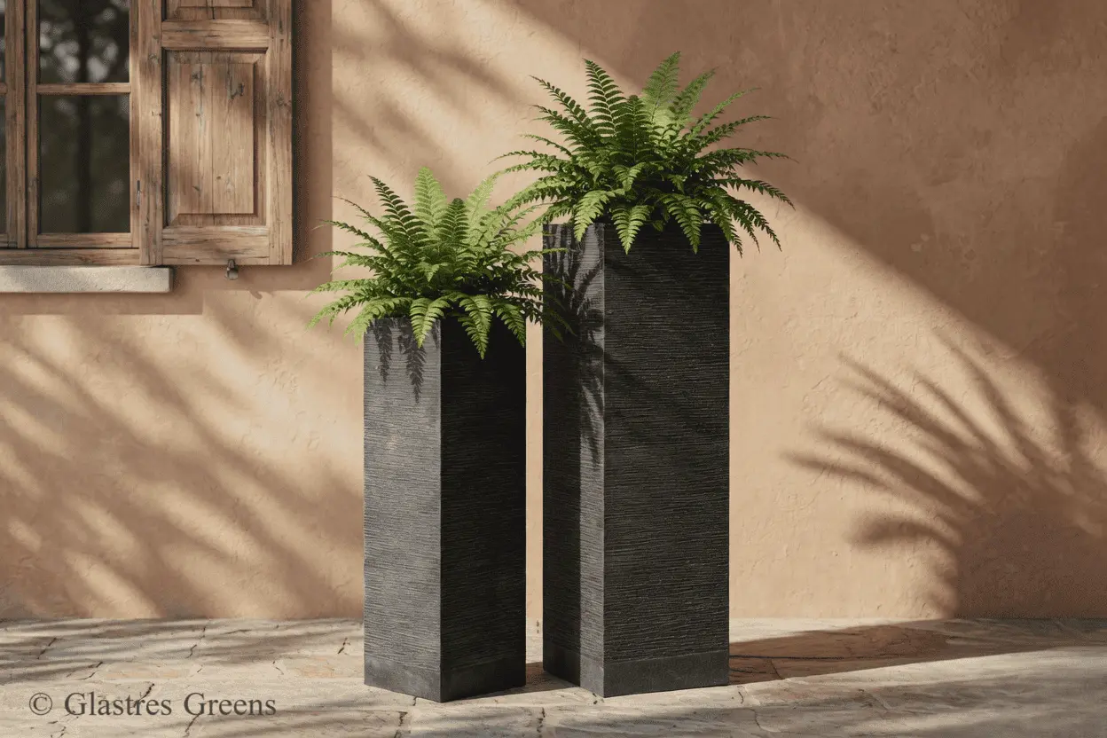 A large, tall tower fiberglass planter positioned in a corporate office lobby, adding modern vertical architectural interest to the indoor space.
