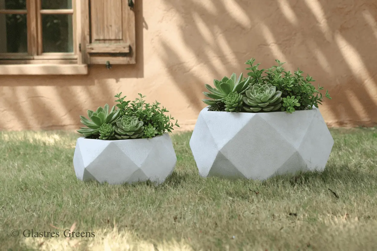 A monsoon-resistant ribbed fiberglass planter located at an outdoor cafe in India, engineered to withstand heavy seasonal rains and high humidity.