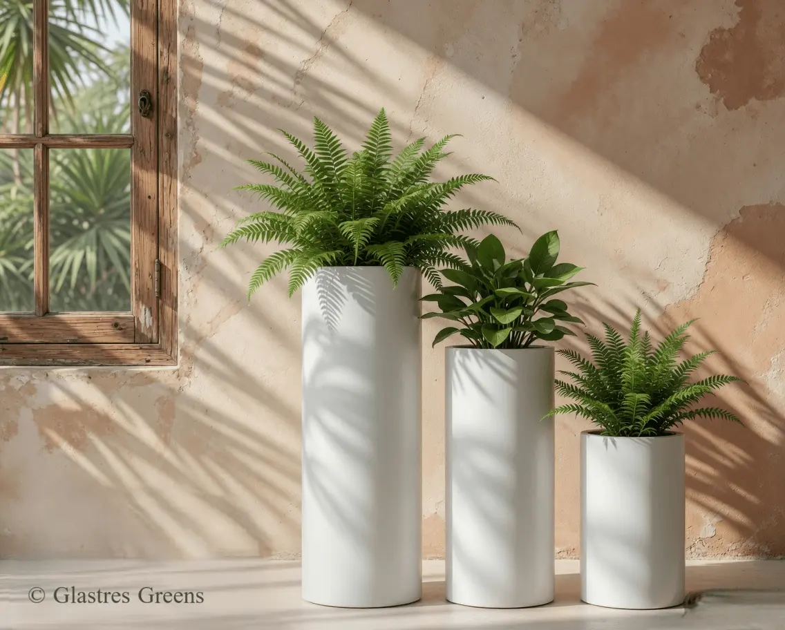 A premium cylindrical fiberglass planter standing guard at a luxury villa entrance, offering a smooth, pillar-like aesthetic to welcome residents and guests.
